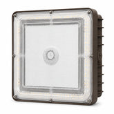 A square industrial LED light fixture with a clear protective lens, showing the internal LED strip and a brown metal housing with side heat fins.