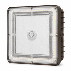 A square industrial LED light fixture with a clear protective lens, showing the internal LED strip and a brown metal housing with side heat fins.