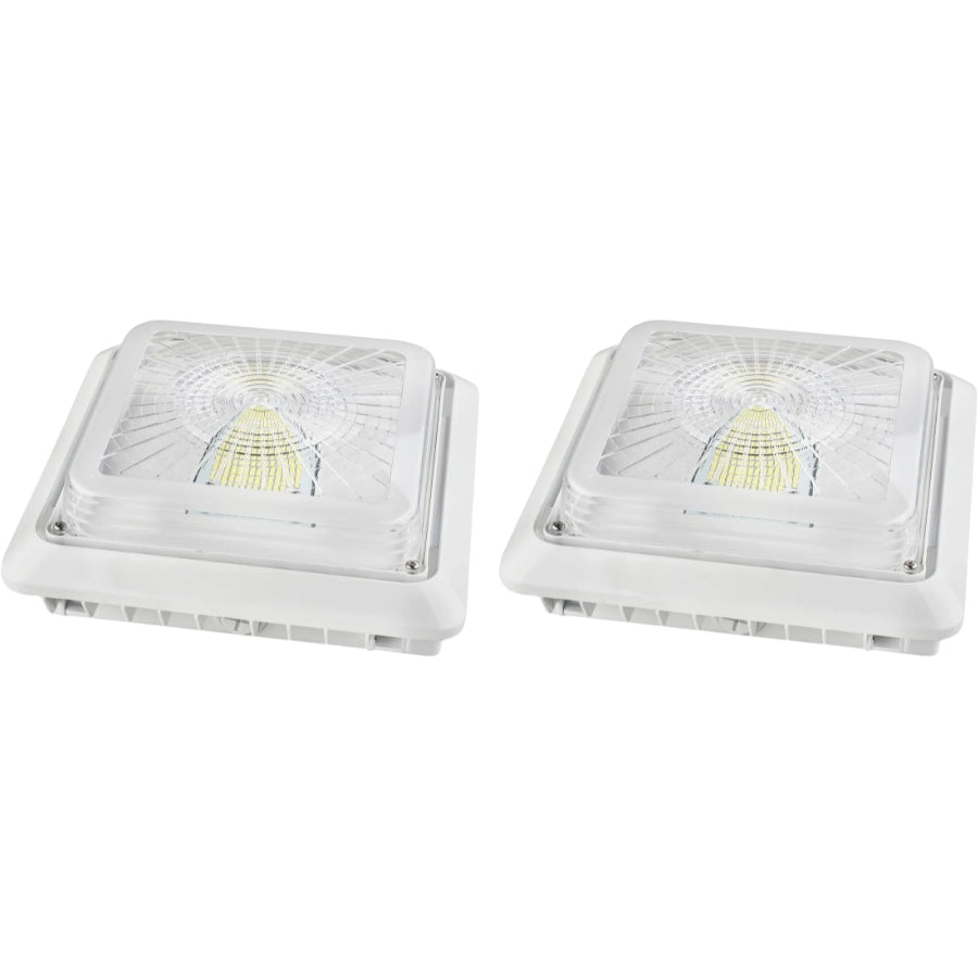Two square white outdoor LED light fixtures with clear protective covers, shown side by side on a plain white background.
