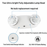 White dual-head emergency exit light with text callouts reading 'Two Ultra-bright Fully Adjustable Lamp Head,' 'No bulb replacement required,' 'Injection-molded Thermoplastic ABS Housing,' 'Test Switch And Charge Indicator,' and 'UL-94V-0 Flame Rating,' plus a circular inset showing the test switch.